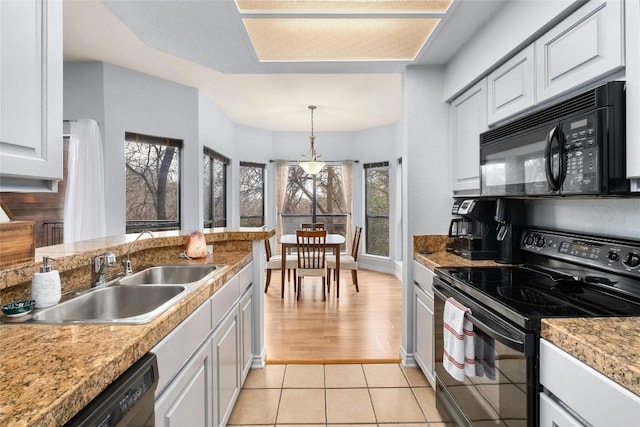 kitchen with pendant lighting, white cabinetry, sink, light tile patterned floors, and black appliances