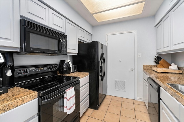 kitchen featuring white cabinetry, black appliances, and light tile patterned flooring