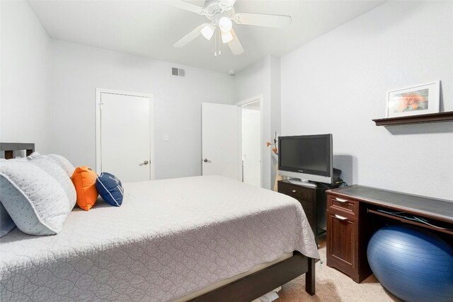 bedroom with ceiling fan and light colored carpet