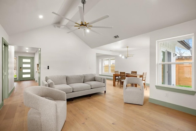 living room with ceiling fan, beam ceiling, high vaulted ceiling, and light wood-type flooring