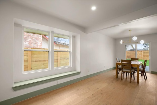 dining area featuring hardwood / wood-style flooring and beamed ceiling