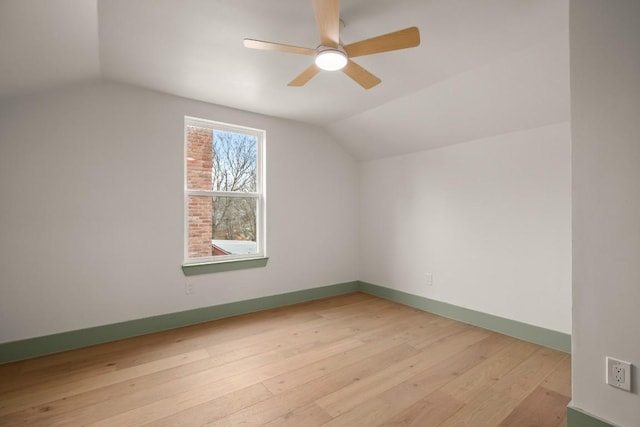 additional living space with lofted ceiling, light hardwood / wood-style floors, and ceiling fan