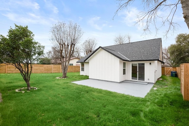 back of property featuring a yard and a patio area