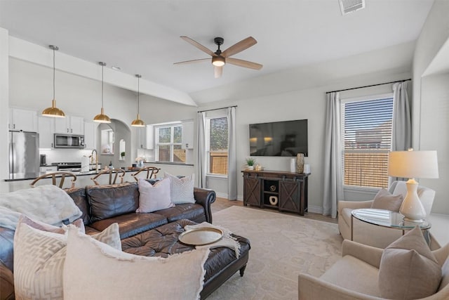 living room with vaulted ceiling and ceiling fan