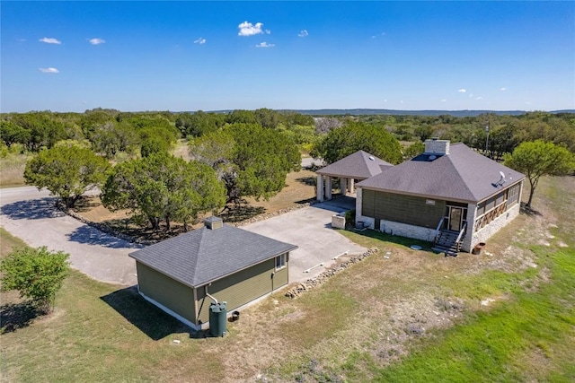 birds eye view of property with a view of trees