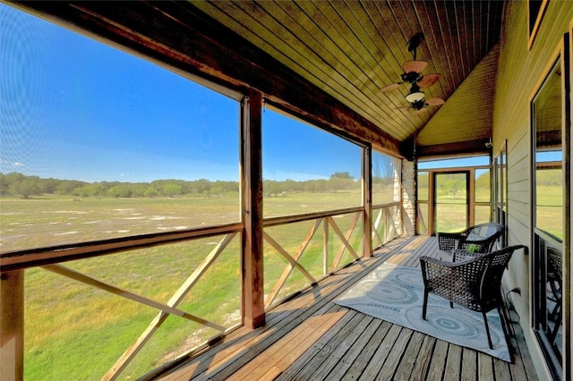 deck with ceiling fan and a rural view