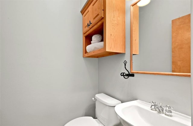 half bath with a sink and toilet