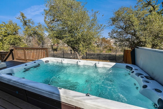 view of pool with a covered hot tub and a deck