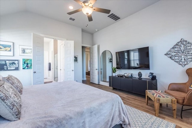 bedroom with hardwood / wood-style flooring, vaulted ceiling, and ceiling fan