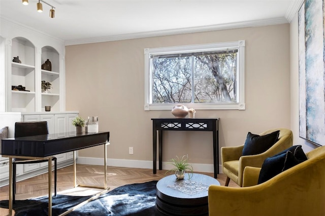 sitting room with parquet floors, crown molding, and built in features