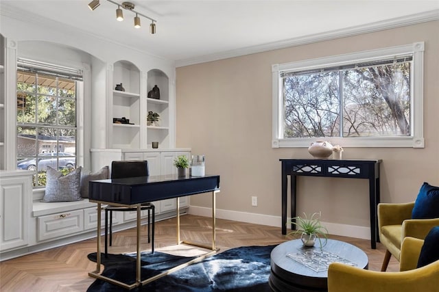 office area with crown molding, light parquet flooring, and built in shelves