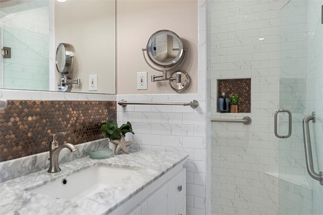 bathroom featuring vanity, a shower with door, and tile walls