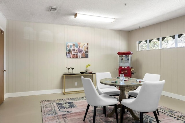 dining area featuring concrete flooring and a textured ceiling