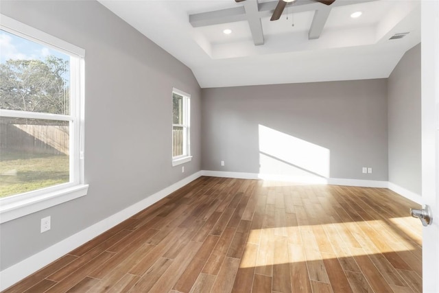 spare room featuring ceiling fan, wood-type flooring, coffered ceiling, and lofted ceiling with beams