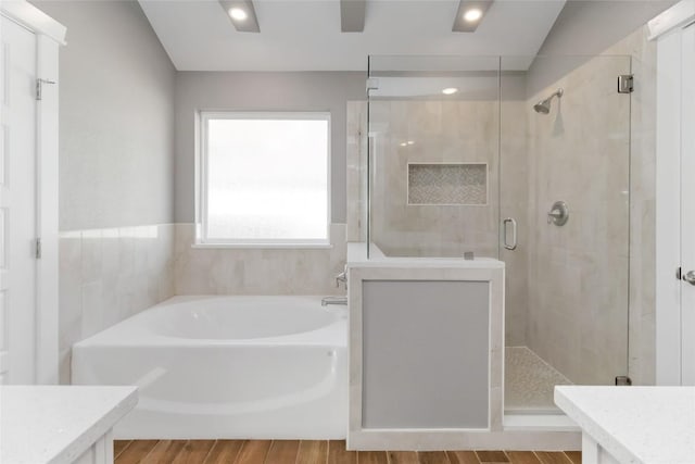 bathroom with vanity, hardwood / wood-style flooring, and independent shower and bath