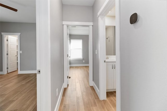 corridor with light wood-type flooring