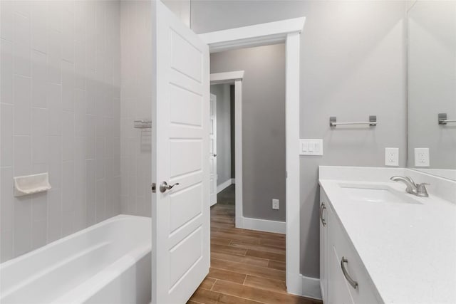 bathroom featuring vanity and tiled shower / bath