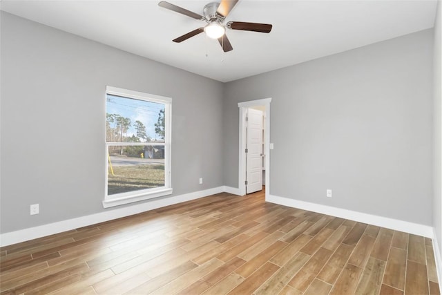 spare room with hardwood / wood-style flooring and ceiling fan