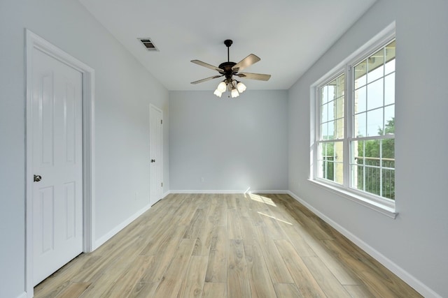 spare room with ceiling fan and light wood-type flooring