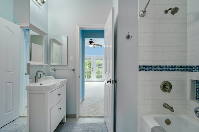 bathroom featuring french doors, tile patterned floors, vanity, tiled shower / bath combo, and ceiling fan