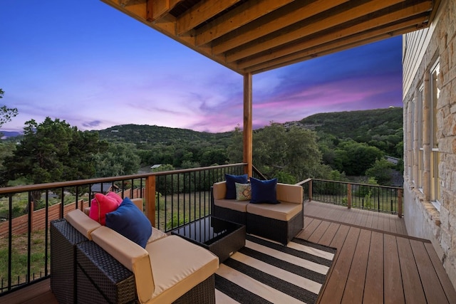 deck at dusk with an outdoor living space