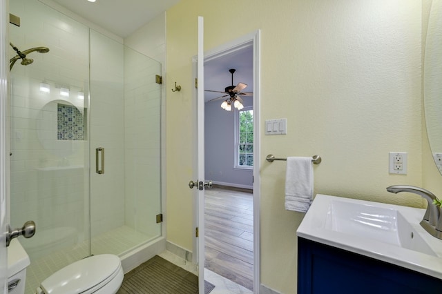 bathroom with vanity, toilet, and a shower with shower door