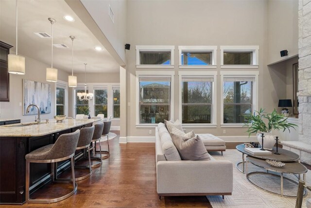 905 Madison Fork Dr, Lakeway, TX 78738 - living area with a high ceiling, dark wood finished floors, a chandelier, and recessed lighting