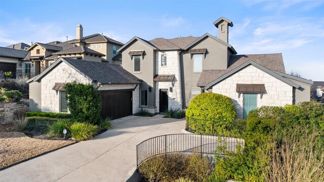 905 Madison Fork Dr, Lakeway, TX 78738 - french provincial home featuring concrete driveway, a shingled roof, an attached garage, stone siding, and a chimney