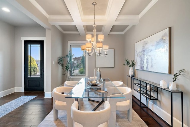 dining room with dark wood-type flooring, coffered ceiling, crown molding, a chandelier, and beamed ceiling