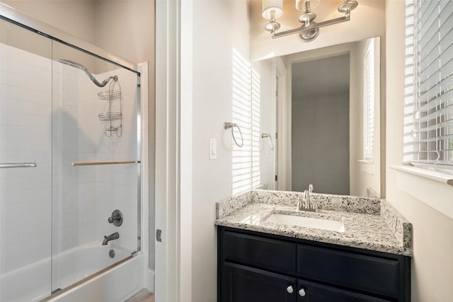 bathroom with enclosed tub / shower combo and vanity