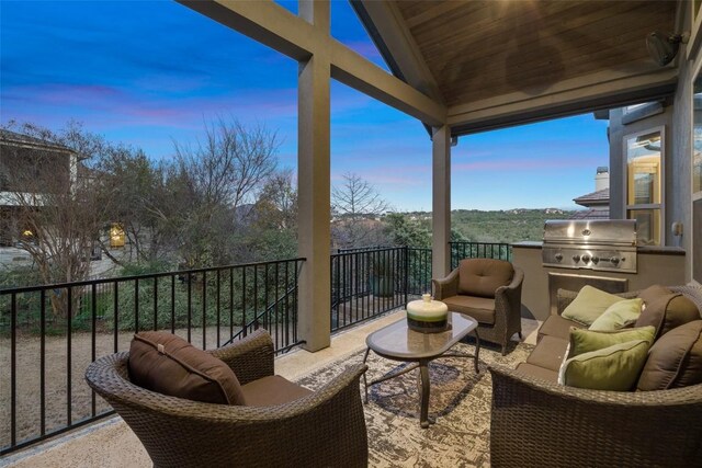 905 Madison Fork Dr, Lakeway, TX 78738 - balcony at dusk with an outdoor hangout area and exterior kitchen