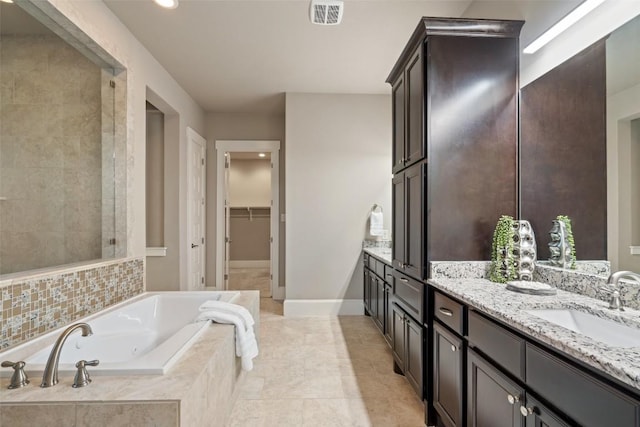 905 Madison Fork Dr, Lakeway, TX 78738 - full bathroom with double vanity, a tub with jets, a spacious closet, and recessed lighting