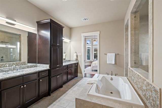 905 Madison Fork Dr, Lakeway, TX 78738 - full bathroom featuring double vanity, a bath, ensuite bathroom, and tile patterned flooring