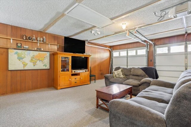 carpeted living room with wooden walls and a textured ceiling