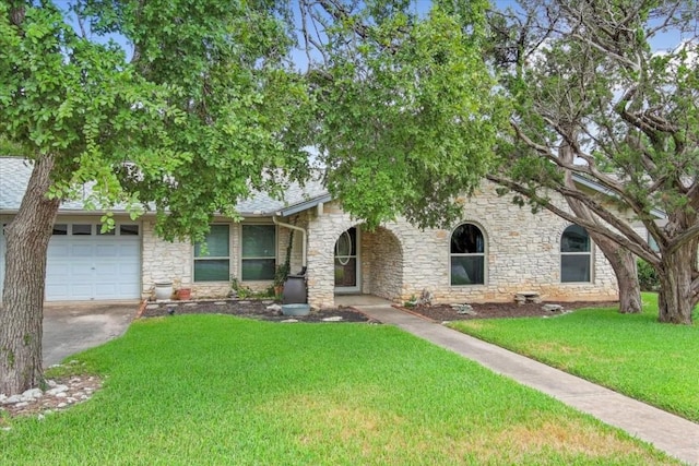 view of front of home featuring a garage and a front lawn