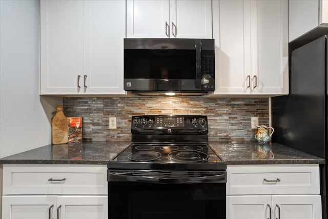 kitchen featuring white cabinetry, dark stone counters, and black appliances