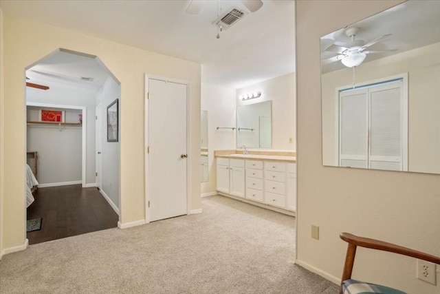 interior space featuring vanity and ceiling fan