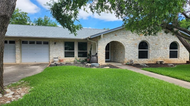 view of front of property with a garage and a front yard