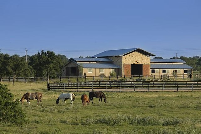 view of stable with a rural view