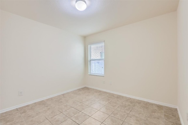 unfurnished room featuring light tile patterned floors