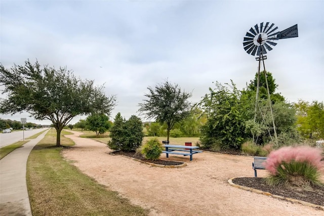 view of property's community with a lawn