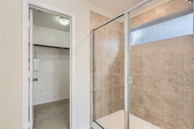 bathroom featuring a shower with shower door