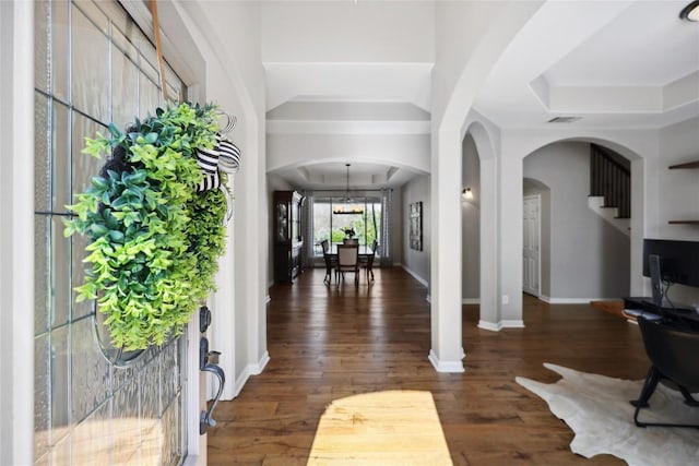 entryway featuring dark hardwood / wood-style floors and a tray ceiling