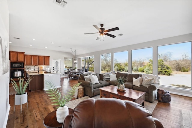 living room with ceiling fan, dark hardwood / wood-style floors, and sink