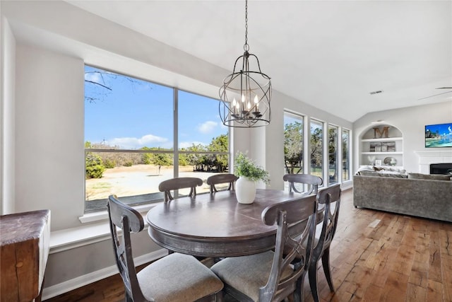 dining room featuring built in shelves and hardwood / wood-style flooring