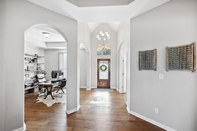 entryway featuring an inviting chandelier and wood-type flooring