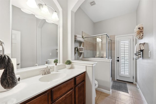 bathroom with vanity, tile patterned floors, toilet, and walk in shower