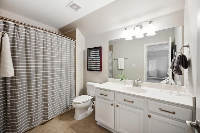 bathroom with vanity, tile patterned floors, and toilet