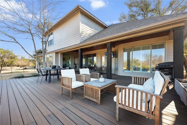 wooden terrace with area for grilling and outdoor lounge area