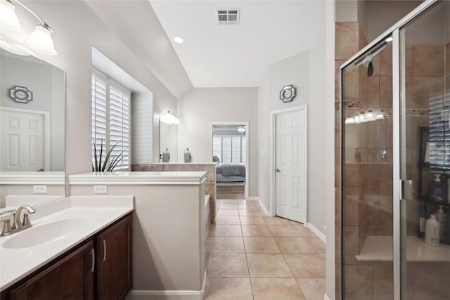 bathroom featuring tile patterned flooring, vanity, and an enclosed shower